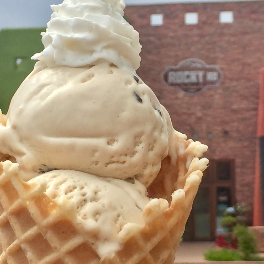 Handcrafted ice cream cone in front of the Rocky RD brick building